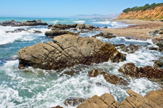 waves breaking on a rocky shoreline sunny day - Classroom Clip Art