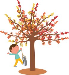 boy playing in the autum with fall folliage on tree