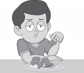 boy showing vegetables from his meal with less interest