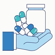 hand is holding blue and white pill capsules