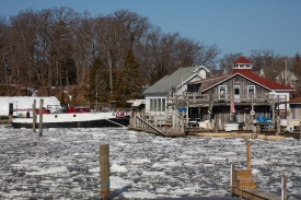 A boat on and in ice on the Black River