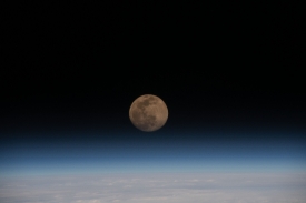 a full moon above the earths horizon