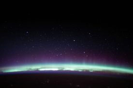 a radiant aurora crowns the earths horizon