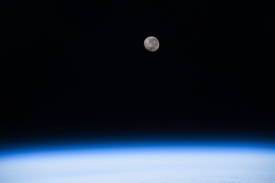 a waning gibbous moon above the earths horizon