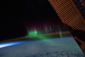 a wispy aurora australis intersects with the earths airglow