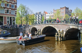 Amsterdam tourist canal boat navigating waterways