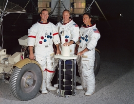 Apollo 15 crew poses with sub-satellite in front of LRV