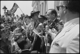 Arkansas Governor Orval Faubus speaking in front of a crowd of p