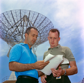 astronaut are shown looking over training plans at Cape Kennedy 