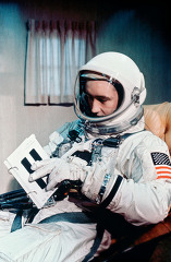 Astronaut James McDivitt shown in full spacesuit in the suit tra