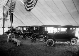 Automobiles on display in tent 1921