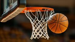 Basketball swishes through the net during an indoor game at a sp