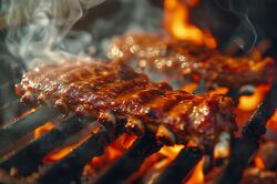 BBQ ribs sizzling on a grill with smoke rising