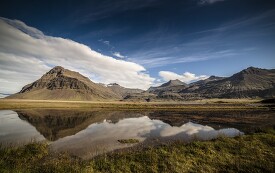 beautiful scenic photo of mountains reflected in lake in iceland