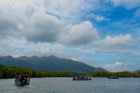 blue sky with puffy clouds over traditional boats langkawi islan