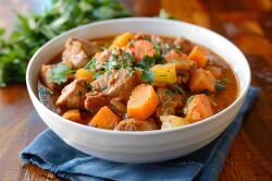 bowl of hearty stew filled with chunks of meat and vegetables
