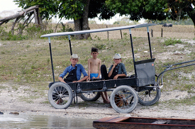 Boys sitting in carriage along river in Belize