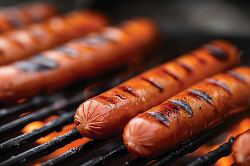 charred hotdogs on the grill