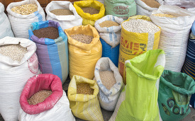colorful bags of grains and seeds in an outdoor market in marake