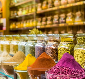 Colorful spice assortment in glass jars at a spice bazaar