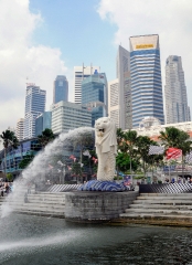 Famous Merlion statue with high rise buildings in background