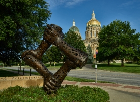 gilded dome of the Iowa capitol forms a backdrop for artist Mich