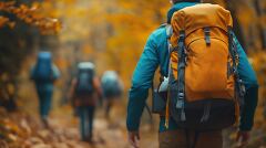 Hikers Explore Autumn Forest Paths With Vibrant Backpacks