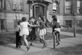 kids Jumping rope on sidewalk in neighborhoods of the Black Belt