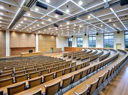 large modern lecture hall with rows of empty seats