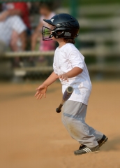 little league baseball player with bat