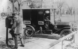 Mailman emptying mailbox 1920