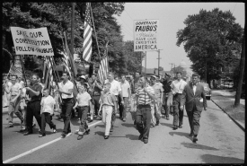 Men and boys marching from the Arkansas State Capitol to Central