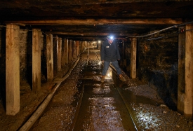 mine guide walks the tracks within 1500 feet of underground pass