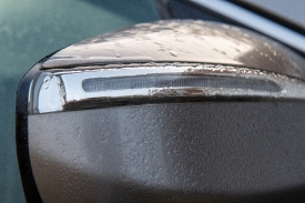morning moisture accumulates on car mirror