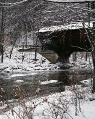 now topped covered bridge in Vermont