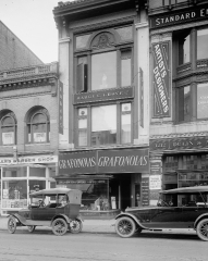 old store front with automobiles parked in front 1918