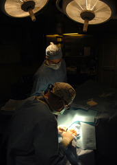 ophthalmologist performs eye surgery