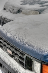 parked cars covered with a layer of ice winter