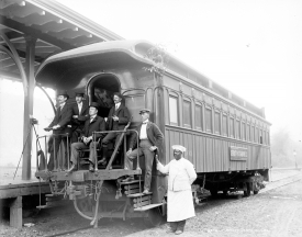 People standing on train car