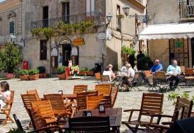 people-sitting-outdoors-in-small-plaza-erice-sicily