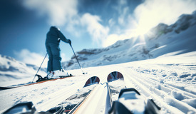 Perspective of a skier with ski poles on a snowy mountain ready 