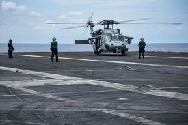 sailors prepare an MH-60S Sea Hawk for take-off from the flight 