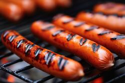 several hot dogs on the grill