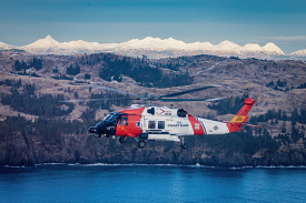 Sikorsky MH 60T Jayhaw flies over the rugged coast of alaska