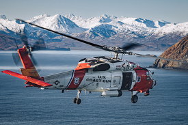 Sikorsky MH 60T Jayhawk helicopter flyies over the alaskan waters