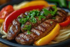 Sliced Grilled Steak With Colorful Vegetables and Noodles