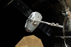 spacex dragon cargo craft in the grips of canadarm 2