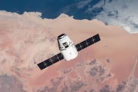 spacex dragon cargo craft over desert approaches iss