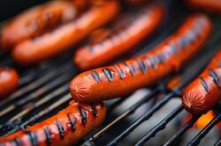 summer barbacue with hotdogs on the grill