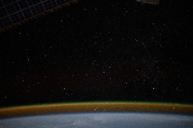 the airglow blankets the earths horizon beneath a starry sky